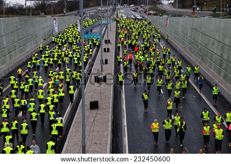 STOCKHOLM - NOVEMBER 22, 2014: Lot of runners in yellow vests in the Tunnel Run (10 km) in Stockholm, Sweden