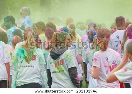 STOCKHOLM - MAY 23, 2015: Rear view of a group of participants covered with color powderin the public event The Color Run, May 23, 2015 in Stockholm, Sweden