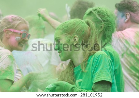 STOCKHOLM - MAY 23, 2015: Young girl covered with green color powder in the public event The Color Run, May 23, 2015 in Stockholm, Sweden