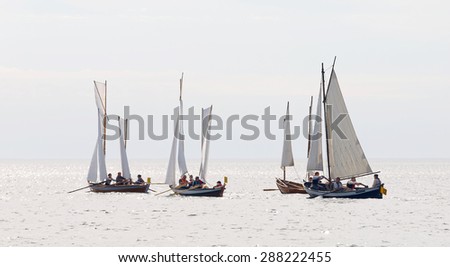 GRISSLEHAMN - JUN 13, 2015: Group of old sailing ships in bright light rowing from Grisslehamn (Sweden) to Eckero (A?land) in the public event Postrodden, June 13, 2015 in Grisslehamn, Sweden