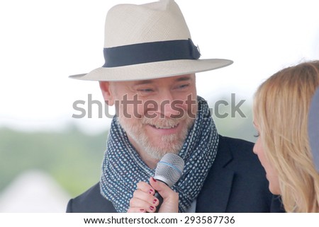 STOCKHOLM - JUNE 06, 2015: World famous clothes designer Lars Wallin interviewed as one of the judges at the hat parade at Nationaldags Galoppen at Gardet. June 6, 2015 in Stockholm