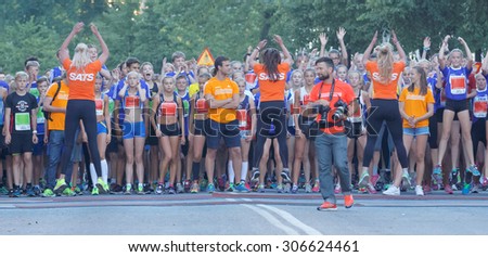 STOCKHOLM, SWEDEN - AUG 15, 2015: Gym instructors warming up the runners before the start start signal in  the running event Midnattsloppet, August 15, 2015 in Stockholm, Sweden