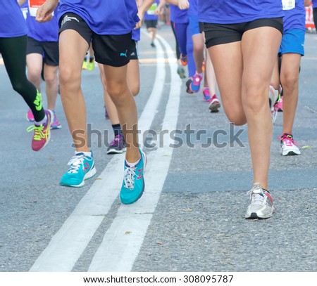 STOCKHOLM, SWEDEN - AUG 15, 2015: Group of colorful running feet and legs in the running event Midnattsloppet, August 15, 2015 in Stockholm, Sweden