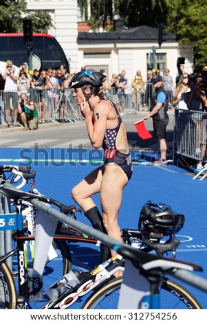 STOCKHOLM - AUG 22, 2015: Katie Zaferes (USA) is the lead in the transition zone from swimming to cycling in the Women\'s ITU World Triathlon series event August 22, 2015 in Stockholm, Sweden
