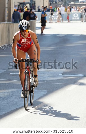 STOCKHOLM - AUG 22, 2015: Triathlete Elena Danilova standing up cycling in the Women's ITU World Triathlon series event August 22, 2015 in Stockholm, Sweden