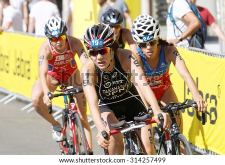 STOCKHOLM - AUG 22, 2015: Close-up of triathlete Yuko Takahashi  (JPN) cycling, followed by competitors in the Women\'s ITU World Triathlon series event August 22, 2015 in Stockholm, Sweden