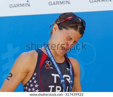 STOCKHOLM - AUG 22, 2015: Sarah True getting champagne in her eyes during the prize ceremony in the Women\'s ITU World Triathlon series event August 22, 2015 in Stockholm, Sweden