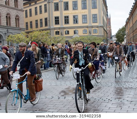 STOCKHOLM - SEPT 19, 2015: Group of elegant cycling people wearing old fashioned tweed clothes in the Bike in Tweed event September 19, 2015 in Stockholm, Sweden