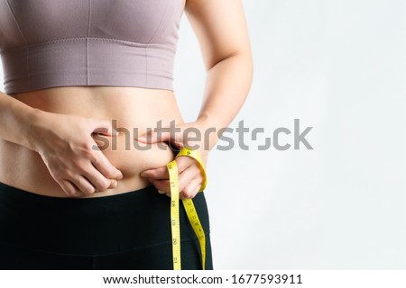 fat woman, fat belly, chubby, obese woman hand holding excessive belly fat with measure tape, woman diet lifestyle concept Imagine de stoc © 