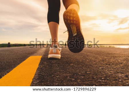 Athlete running on the road trail in sunset training for marathon and fitness. motion blur of woman exercising outdoors Imagine de stoc © 