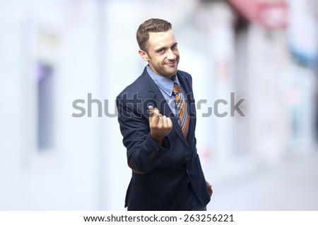Man in suit Money gesture next to a cashier