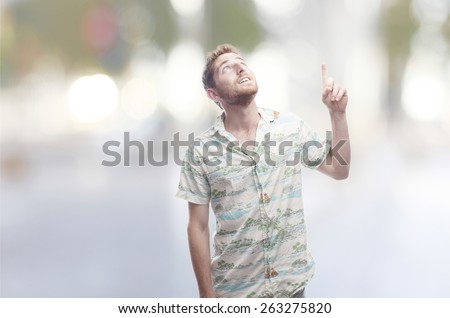 ginger young man pointing up with abstract background