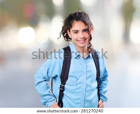 latin girl smiling with satchel on the street