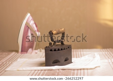 vintage iron on the table, contemporary iron, wrinkled white cloth