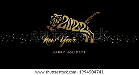 Happy New year 2022. The year of the tiger of lunar Eastern calendar. Creative tiger logo and number 2022 on a black background. Happy New Year Greeting Card.