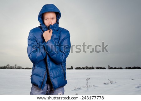 Asian man in blue down-padded coat winter outdors