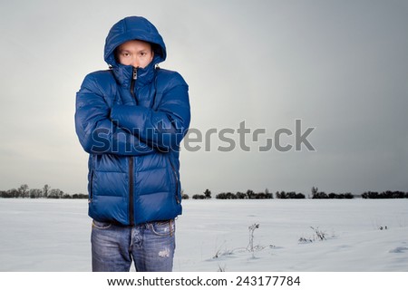 Asian man in blue down-padded coat winter outdors