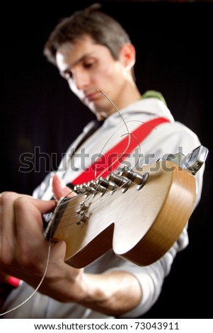 male with red elegtric guitar, playing solo