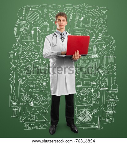 male doctor in suit with laptop in his hands, looking on camera