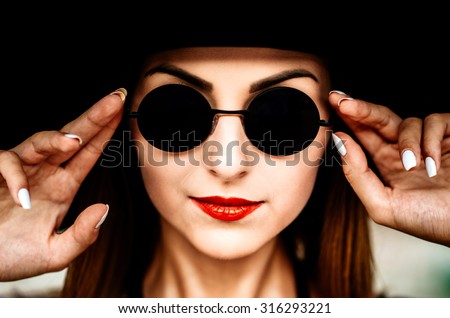 Portrait of pretty young women outdoor in black hat