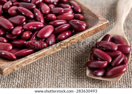 red kidney bean in wood bowl and wood spoon on gunny