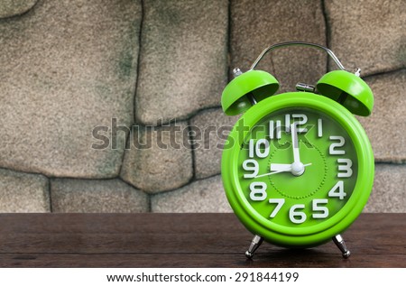 Clock on Wooden Floor with Stone Background