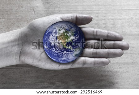 Woman holding global in hand , Elements of this image furnished by NASA