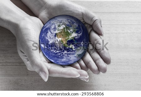 Woman holding global in hands , Elements of this image furnished by NASA