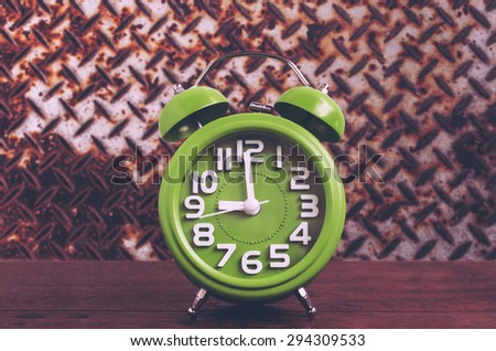 Clock on Wooden Floor with Steel Plat Grunge Background , Vintage Style