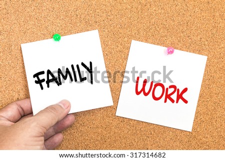 paper note with text ( family or work ) pin on corkboard  with hand holding , decision concept