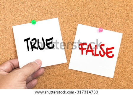 paper note with text ( true or false ) pin on corkboard  with hand holding , decision concept