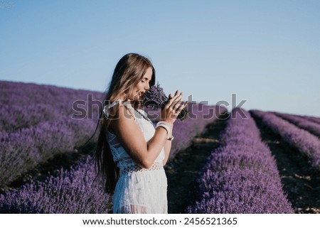 Image, Stock Photo Young woman smelling flower in the field