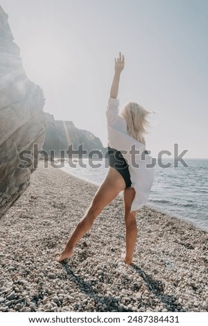 Similar – Image, Stock Photo Woman on stony seashore looking on foamy water washing peaks