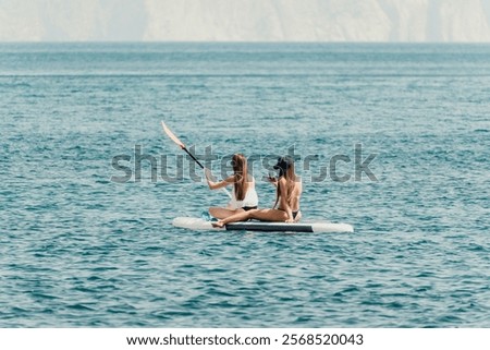 Similar – Image, Stock Photo Woman floating on paddleboard in lake