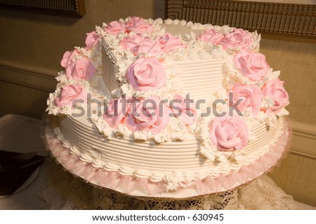 Delicious wedding cake with pink flowers, sweet white icing, vanilla cake with cherries filing.