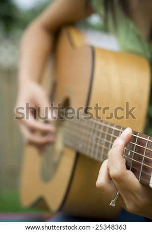Young Woman Playing the Guitar