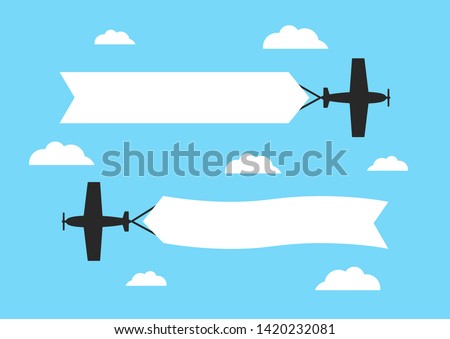 Flying airplanes with advertising banners on blue background. Planes with blank ribbons.