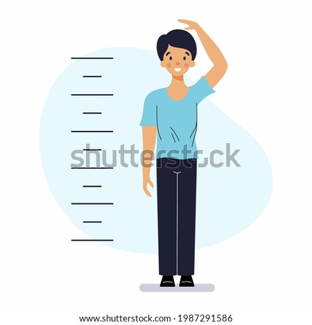 Boy measures his height with  ruler. Height meter for children.