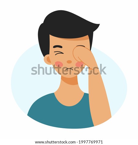 Boy rubs his face with his hand. Conjunctivitis in child. Inflammation and injury of eye. Tearfulness. Symptom of  eye disease.