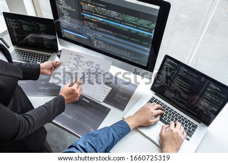 Professional Team of programmer working on project in software development computer in IT company office, Writing codes and data code website and coding database technologies on new Application.