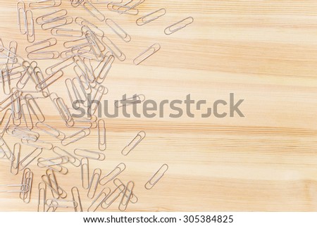 pile of paper clips on a background of a wooden table