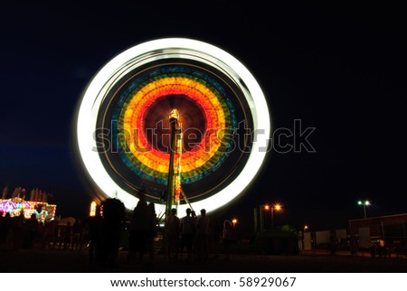 Ferris wheel motion blur at night at carnival