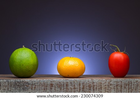 Lime orange and tomato lined up as traffic lights