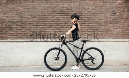 Similar – Image, Stock Photo Positive female cyclist resting on street