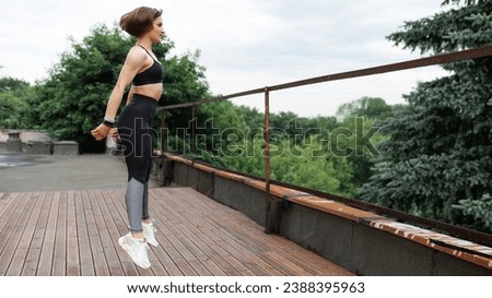 Similar – Image, Stock Photo Sportswoman jumping on terrace during training