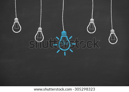 Idea Light Bulb Concept Working on Blackboard
