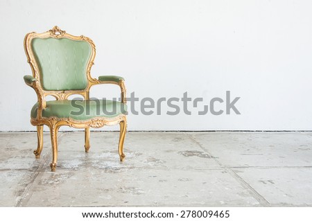 Luxury green vintage style armchair sofa in a vintage room