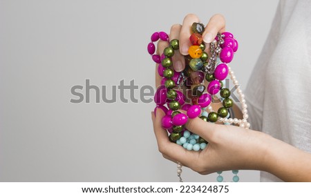 Young woman\'s hands with jewelry, beads. /Girl\'s hands with jewelry