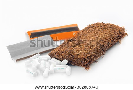 Tobacco  and cigarette\'s rolling paper and filters on a white background