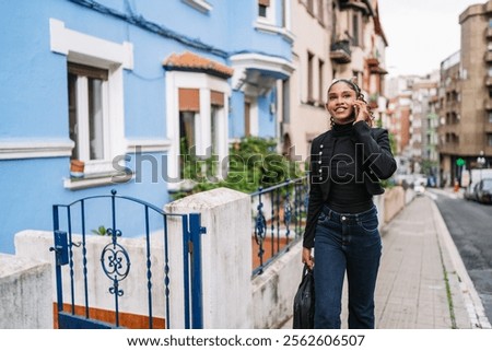 Similar – Foto Bild Elegante ethnische Geschäftsfrau zu Fuß in der Innenstadt mit Tasse Kaffee